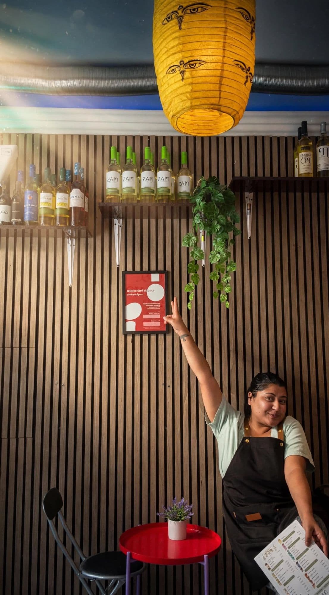 Founder of Chapter 1, menu in hand, under the Buddha-eyes lantern